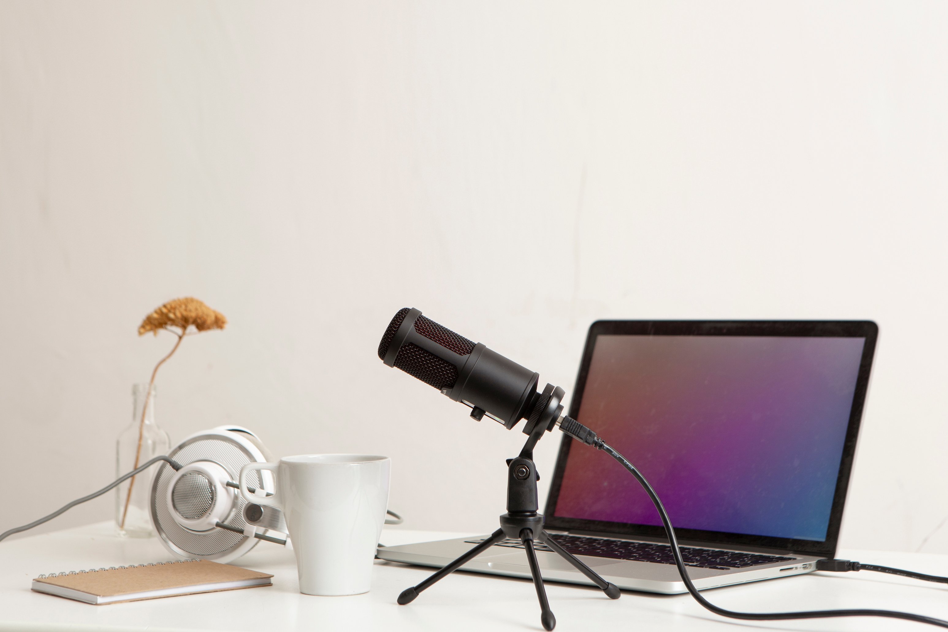 Headphones, Microphone, Laptop and Notebook on White Desk